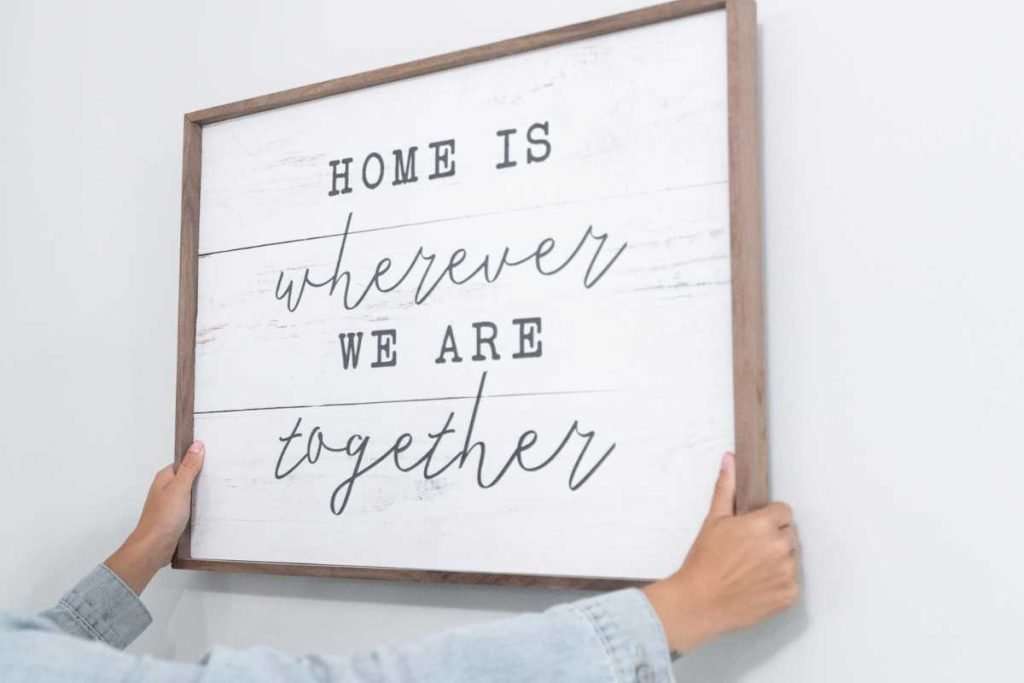 farmhouse sign saying home is where we are together